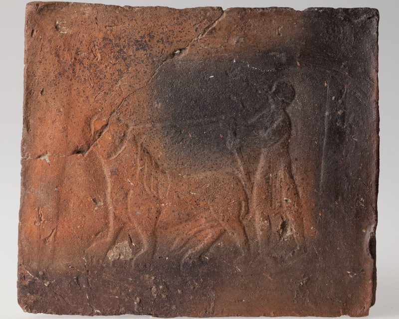 Płytka przedstawiająca mężczyznę trzymającego lwa na arkanie